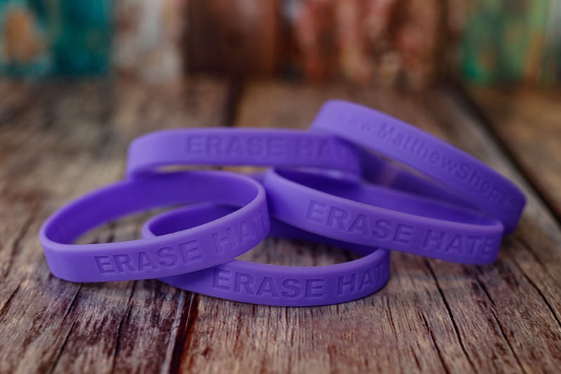 Product Description: Our signature “Erase Hate” wristbands. They are purple rubber embossed with “Erase Hate” and the MSF website. These come in packs of 6. Shipping included.</br> Erase Hate Wristbands - 6 Pack
